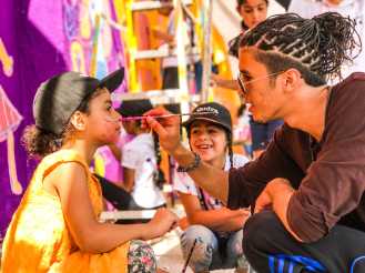 Local artist and dancer Sky, who partnered with us in Amman, doing some face painting.