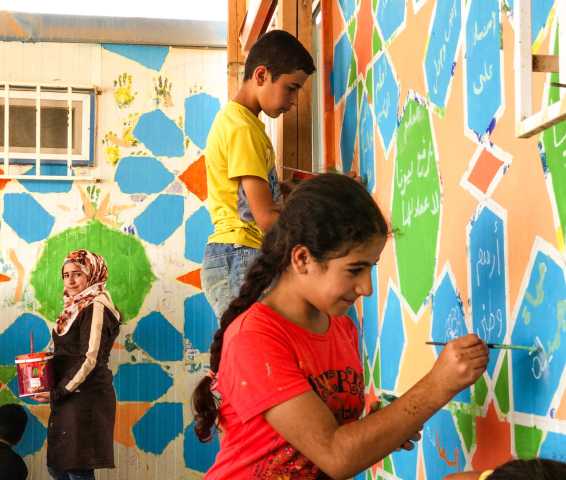 Painting a mural in Za'atari
