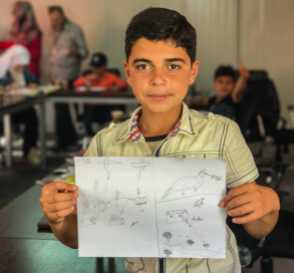 Mohammed, a 14-year-old resident of Za'atari Camp, shows his drawing depicting hope for the future after the horrors of war.