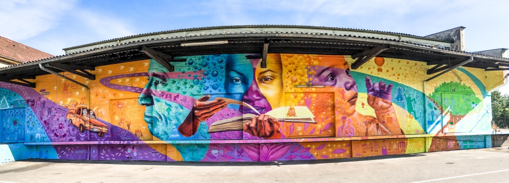 Stuttgart, Germany 2017: Joel worked with youth from Syria, Afghanistan, Iraq, Iran, Gambia, Ghana, the Dominican Republic and Germany, this mural tells the stories of life's journeys from struggle to hope, and of our ability to work in partnership across borders. With Park Inn by Radisson, Stuttgart.