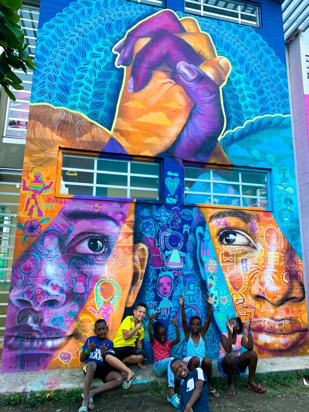 Cali, Colombia 2020: Joel collaborated with local youth and Cali artist Teca to create this mural of unity in the face of violent divisions and xenophobia in the community of Aguablanca. Partners: Artolution, Fundación Pintuco, Centro Cultural Colombo Americano.
